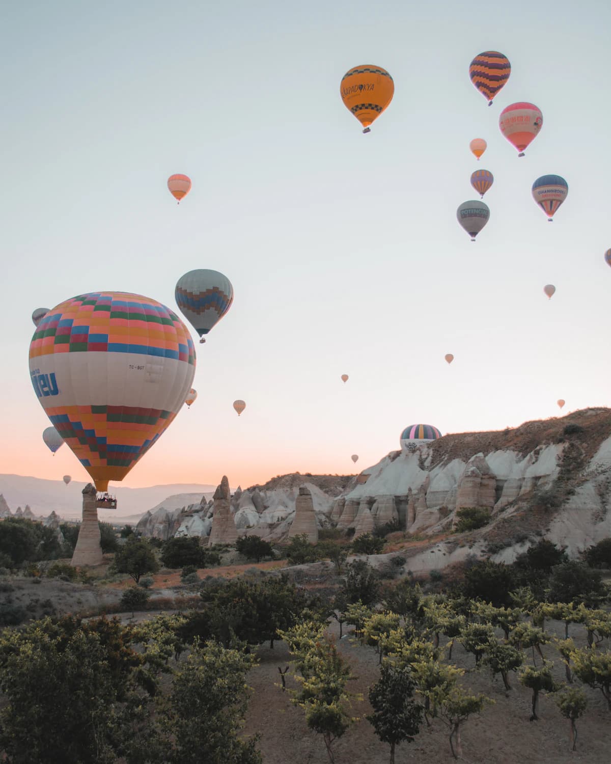 Hot air balloons drifting over the rock valleys of Cappadocia